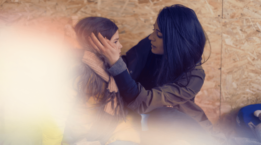 A woman comforts a child in a humanitarian crisis