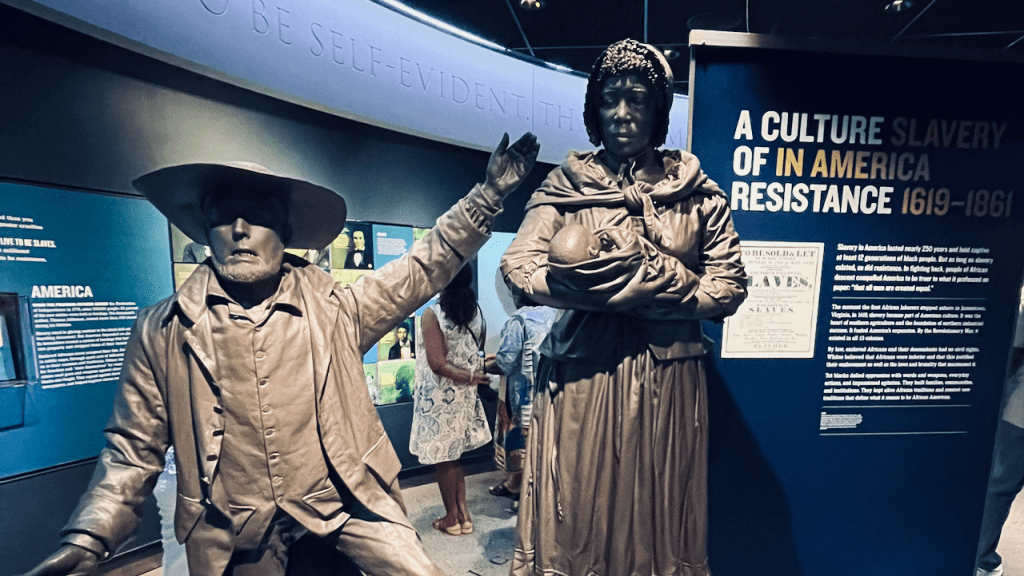 Inside the National Civil Rights Museum at the Loraine Motel in Memphis, TN, a scene depicting the legacy of slavery before the founding of the United States of America of a tradesman selling a black woman and her infant. –Matt Till, June 17, 2024